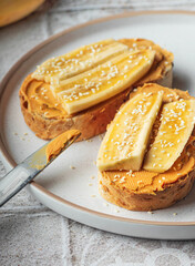 Tasty toast for breakfast with peanut butter and banana close up food photo