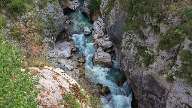 Aerial View Above The Surface Of A Mountain River Soca , stream flowing through rocky canyon. River stones with flowing water, clean water flowing in a mountain river