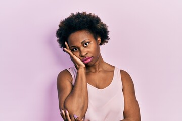 Young african american woman wearing casual sleeveless t shirt thinking looking tired and bored...
