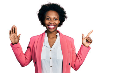 African american woman with afro hair wearing business jacket showing and pointing up with fingers...