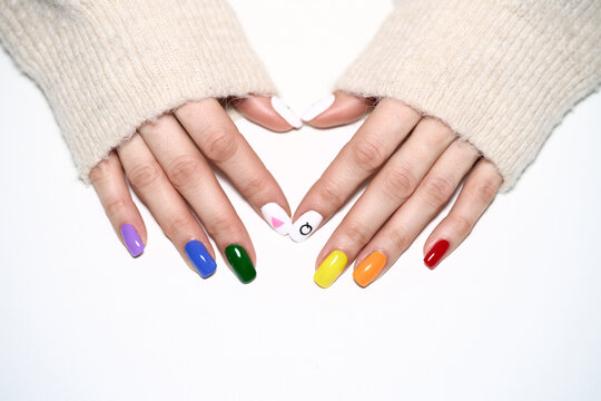 Hands with LGBT rainbow flag and rose triangle manicure. Symbol of lesbian, gay, bisexual, transgender and queer pride isolated on white background. 