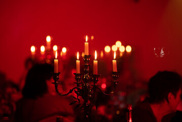 red candlestick. Candles are burning. Candlestick.