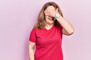 Middle age caucasian woman wearing casual clothes smiling and laughing with hand on face covering eyes for surprise. blind concept.