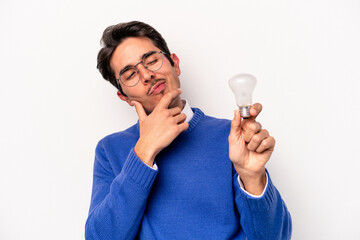 Young caucasian man holding a lightbulb isolated on white background