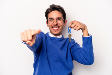 Young caucasian man holding a key chain isolated on white background