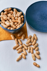 Image of bunch of peanuts in a bowl on a table