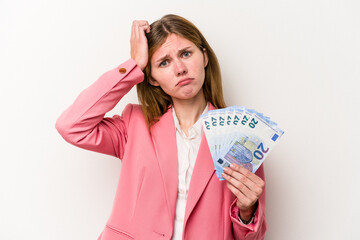 Young business English woman holding banknotes isolated on white background being shocked, she has remembered important meeting.