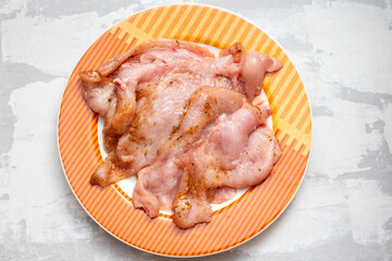 raw meat turkey on orange dish on ceramic