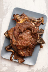 grilled fresh meat on big gray dish on ceramic