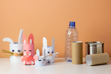 Reuse concept art from tin can, toilet tube, plastic bottle. Eco friendly bunny craft. Handmade decoration easter rabbit