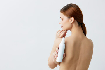 beautiful woman skin care lotion with bare shoulders isolated background