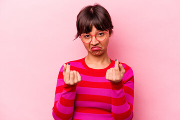 Young hispanic woman isolated on pink background showing that she has no money.