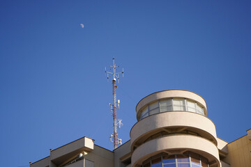 Fototapeta na wymiar gsm antenna located on a block of flats. radiation. photo during the day.