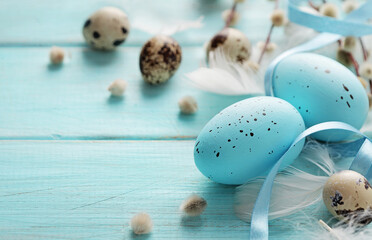 colorful easter eggs and spring flowers, pastel blue background