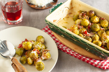 Baked warm salad of brussels sprouts with bacon, red onion and parmesan cheese