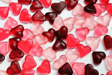 a slide of bright, red and pink, jelly hearts in the glare of light on a light background 