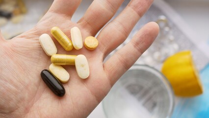In the palm of your hand there are many different tablets and pills that help fight against diseases and coronavirus. The doctor prescribed medications to help her recover and maintain her well-being.