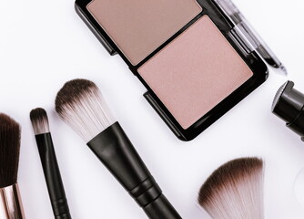 Minimal style,face blush and makeup brushes on white background, flat lay, top view.
