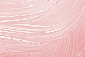 Pink serum gel texture. Clear skincare cream background. Transparent colored cosmetic product close up