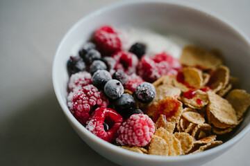 Healthy breakfast with berries, cereals and natural yogurt.