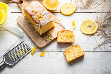 Several slices of lemon cake, lemon sponge cake, homemade, with sugar, flour, honey, yeast and lemons, dessert or for breakfast, on a wooden background.