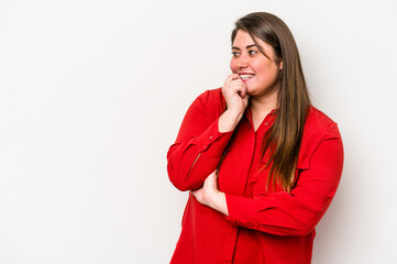 Young caucasian overweight woman isolated on white background relaxed thinking about something looking at a copy space.