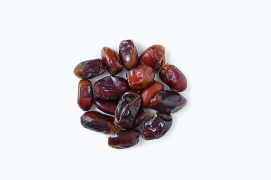 Heap of ripe dried dates. White background.
