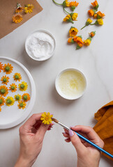 Confectioner is hands make crystallized flowers. Candied edible flowers with egg whites and sugar....