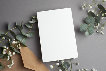 Wedding invitation or greeting card mockup with envelope, eucalyptus and gypsophila plants...