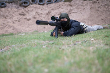 Low angle view of sniper laying on ground