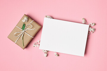 Greeting card mockup with gift box on pink