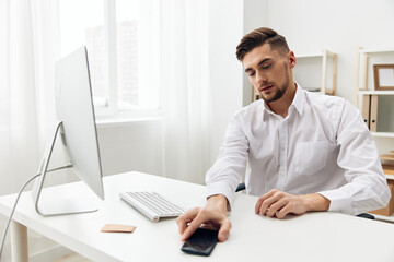 Fototapeta premium handsome man office worker in a white shirt emotions workplace
