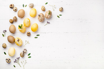 Easter eggs with flowers on a white table.