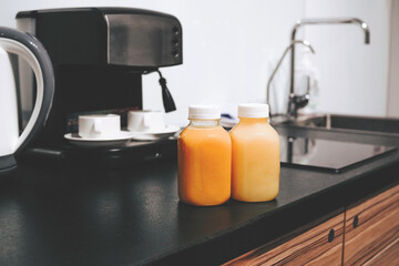 Two bottles of freshly squeezed juice with orange and pineapple. Healthy smoothie for breakfast. Wellness body care. Recovery and detox for the body. The Right Food