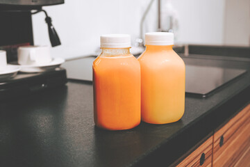 Two bottles of detox smoothie and juice close-up. Freshly squeezed fruit for breakfast. Vitamin detox juices for the body. Diet and body health.