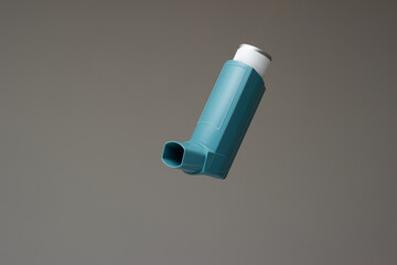 Asthma inhaler, generic, non-branded. Close up studio shot, isolated on gray background