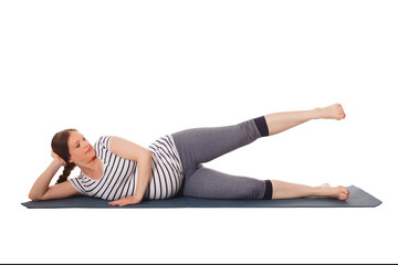 Pregnancy yoga exercise - pregnant woman doing yoga asana Vishnuasana Easy Side Reclining Leg Lift Pose isolated on white background