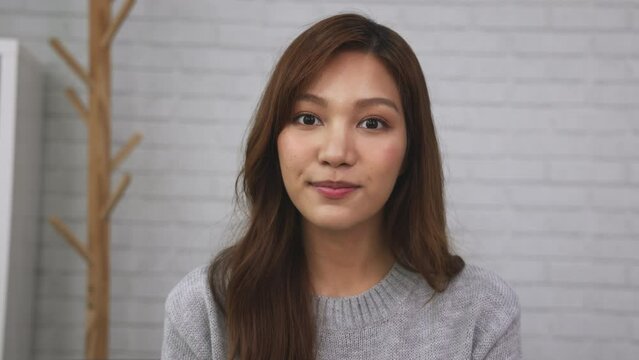 Asian businesswoman looking at camera and video conference with team colleague, Social distancing with online meeting or new normal situation for virus prevention concept
