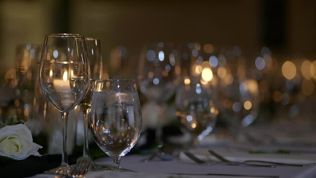 Numerous wine glasses standing in a row