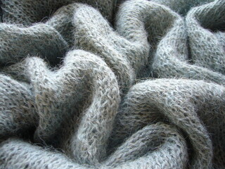 Grey-blue alpaca knit. Knitting. The texture of the fabric.