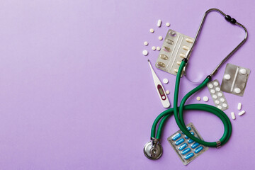 Medical background. Many different various medicine tablets or pills on the table with stethoscope....