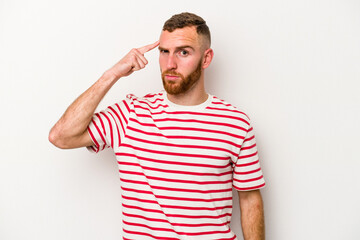 Fototapeta premium Young caucasian man isolated on white background pointing temple with finger, thinking, focused on a task.