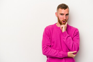 Young caucasian man isolated on white background looking sideways with doubtful and skeptical expression.