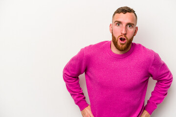 Obraz premium Young caucasian man isolated on white background being shocked because of something she has seen.