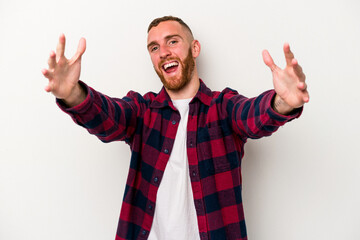 Naklejka premium Young caucasian man isolated on white background celebrating a victory or success, he is surprised and shocked.