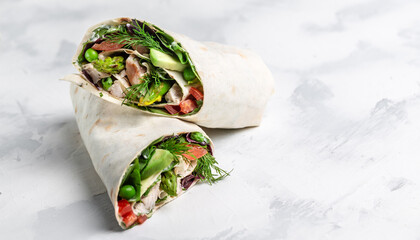 fresh tortilla wraps with vegetables asparagus, avocado, tomatoes, peas, cheese and tartar sauce on...