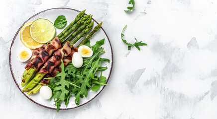 Bacon wrapped asparagus. Healthy diet food for Keto breakfast. Long banner format, top view