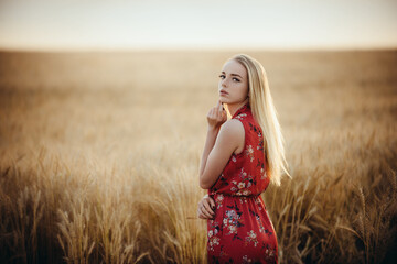 Beautiful young woman in a wheat field