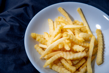 French fries in a plate French fries in a plate. on a dark background .