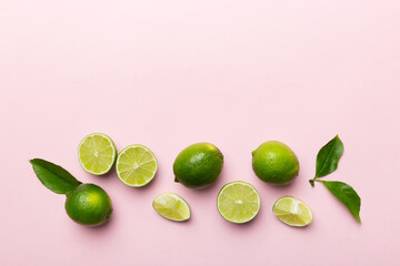 Lime fruits with green leaf and cut in half slice isolated on white background. Top view. Flat lay with copy space